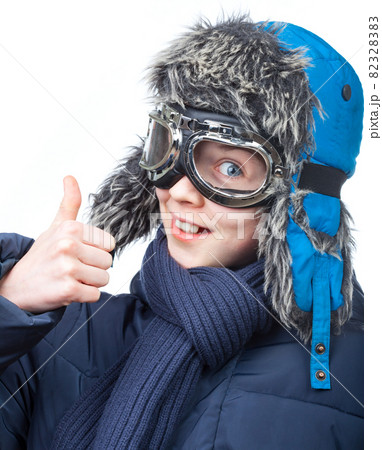 Boy in winter clothing showing thumb up 82328383