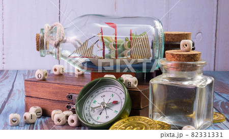boat in  bottle on wood table for travel or transport concept 82331331