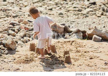 Little Boy Playing in Sand 82334115