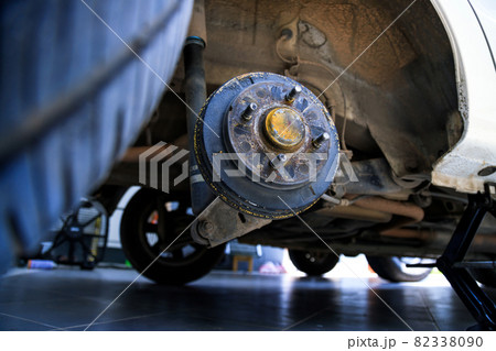 A rear hub of the car after removing a tire and wheel, maintaining a brake and wheel system, car jack-up for change a car wheel, Close-up shot 82338090