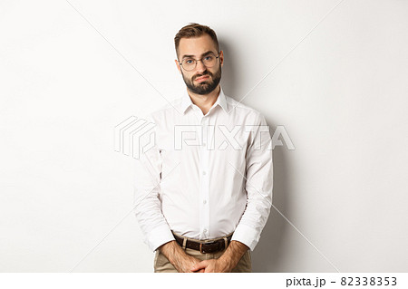 Sad and gloomy office manage frowning, standing tired against white background Sad and gloomy office manage frowning, standing tired against white background 82338353