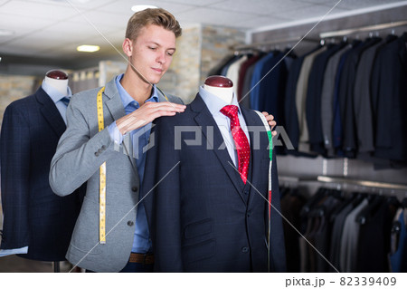 Adult male in shirt measuring jacket 82339409