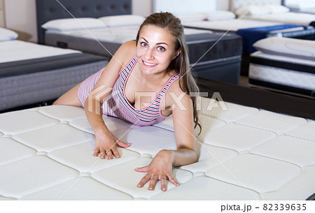 Sexy smiling female lying and shopping mattress 82339635