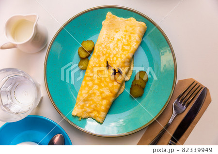 Salty thin pancake with slices of pickled cucumbers and microgreens Salty thin pancake with slices of pickled cucumbers and microgreens 82339949