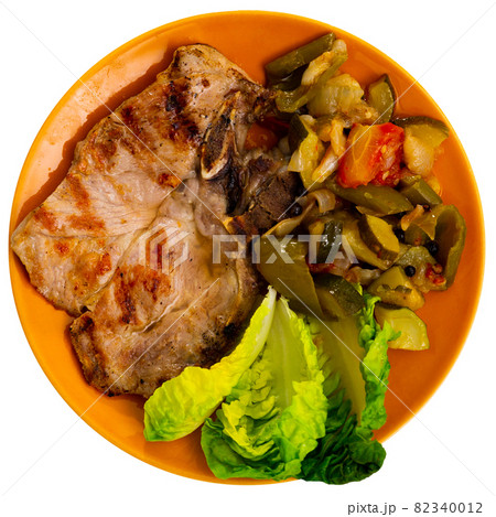 Juicy roast pork on a plate with stewed vegetables Juicy roast pork on a plate with stewed vegetables 82340012