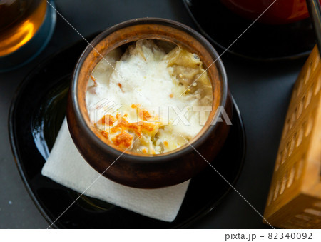Dumplings baked with cream in clay pot. Russian cuisine Dumplings baked with cream in clay pot. Russian cuisine 82340092