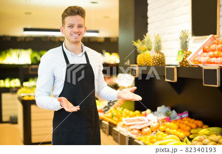 Seller showing assortment of grocery store Seller showing assortment of grocery store 82340193