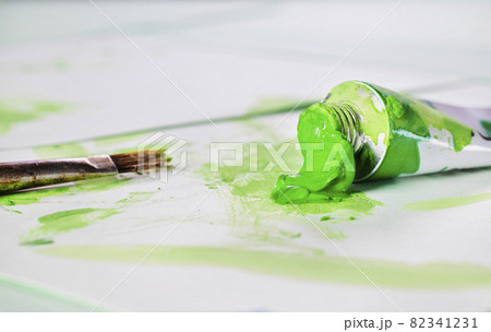 Green tube of paint with brush 82341231