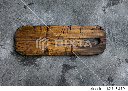 Aged wood cutting board, top view flat lay , with copy space for text or your product, on gray stone table background 82343850