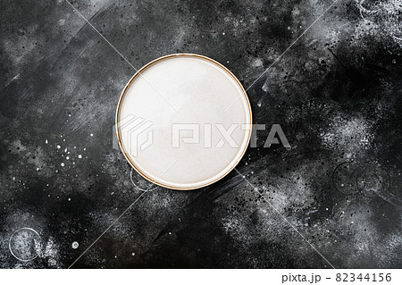 Ceramic empty white plate with copy space for text or food with copy space for text or food, top view flat lay , on black dark stone table background 82344156