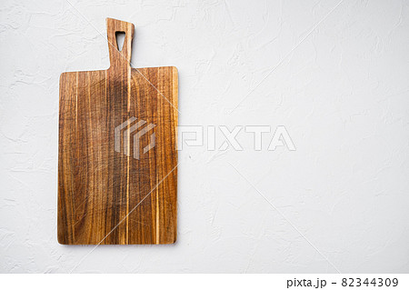 Empty wooden cutting board on a kitchen table. Top view, copy