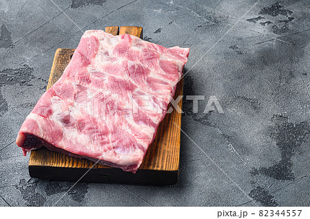 Raw Pork ribs, on wooden cutting board, on gray stone background, with copy space for text Raw Pork ribs, on wooden cutting board, on gray stone background, with copy space for text 82344557