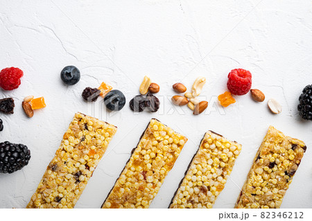 Superfood breakfast bars with oats nuts and berries, top view with copy space, on white background 82346212