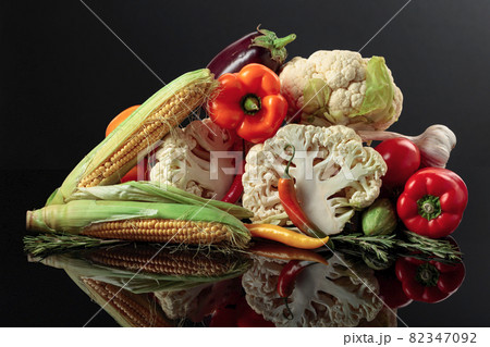 Various fresh vegetables on a black reflective background. 82347092