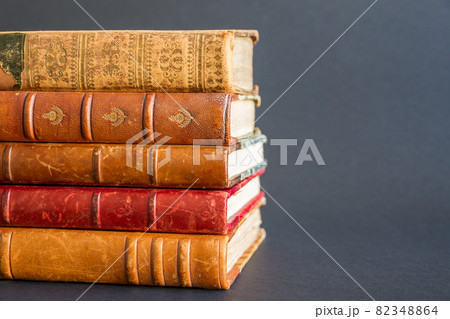 Stack of old books on dark background Stack of old books on dark background 82348864