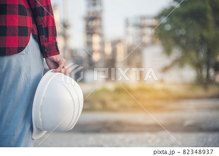Refinery woman engineer oil industry hands hold worker helmet hard hat. Refinery industry engineering. Engineer woman hands holding hardhat white work helmet hard hat for Construction Engineering Refinery woman engineer oil industry hands hold worker helmet hard hat. Refinery industry engineering. Engineer woman hands holding hardhat white work helmet hard hat for Construction Engineering 82348937