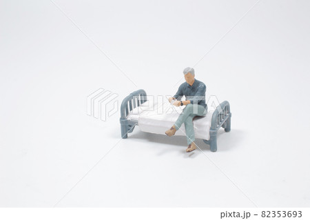 a man sit on the bed and drinking coffee 82353693