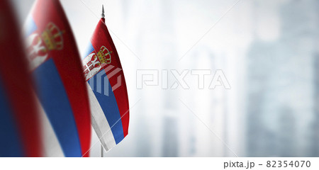 Small flags of Serbia on a blurry background of the city Small flags of Serbia on a blurry background of the city 82354070
