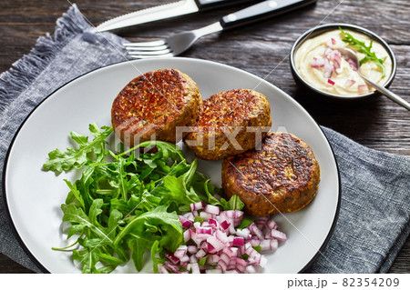 vegan lentil patties with rocket onion salad vegan lentil patties with rocket onion salad 82354209