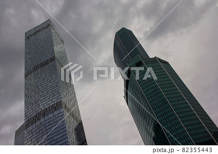 Tall buildings skyscrapers against the clouded sky. Concrete and glass High quality photo 82355443