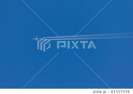 Flying plane leaves an inversion trail in the air. White and blue . nice logo 82355456