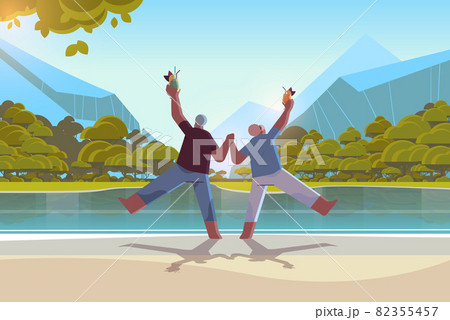 senior couple dancing at lake beach old african american man and woman having fun active old age concept 82355457
