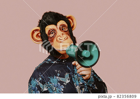 man wearing a monkey mask speaks into a megaphone 82356809