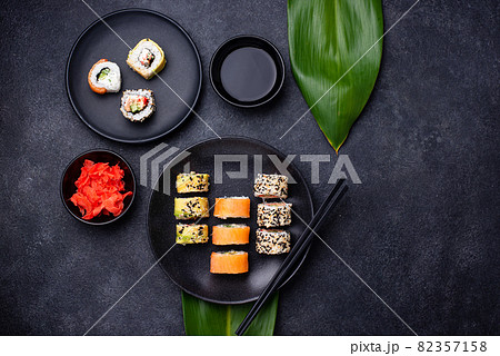 Traditional Japanese sushi rolls on dark background 82357158