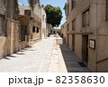 A quiet, urban alley on a bright sunny day in an Arab country. Cairo, Egypt. On the right and left are houses in the Arab style made of sandstone. 82358630