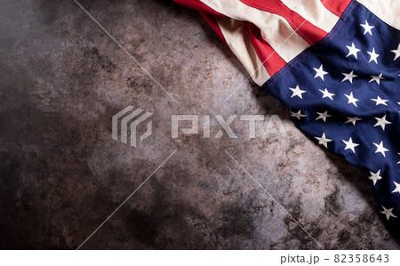 Happy Veterans Day concept. American flags against a dark stone  background. November 11. 82358643