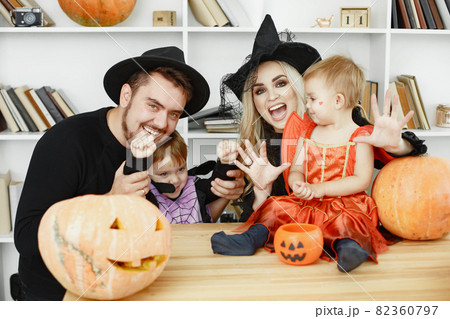Family in costumes getting ready for halloween at home 82360797