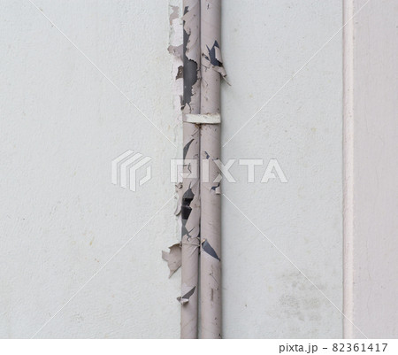 Broken outdoor air conditioner ducts on building wall 82361417