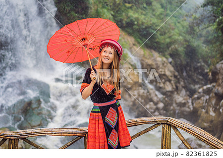 A female tourist dressed in the traditional dress of the inhabitants of the Vietnamese mountains, the Hmong. Woman in Sapa in the fog, Northwest Vietnam. Vietnam travel concept. UNESCO heritage A female tourist dressed in the traditional dress of the inhabitants of the Vietnamese mountains, the Hmong. Woman in Sapa in the fog, Northwest Vietnam. Vietnam travel concept. UNESCO heritage 82361825