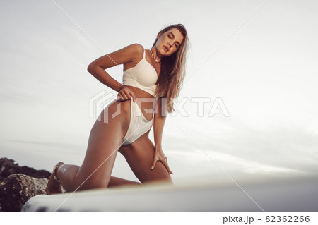 Young beautiful sexy woman posing in sea on a SUP board 82362266