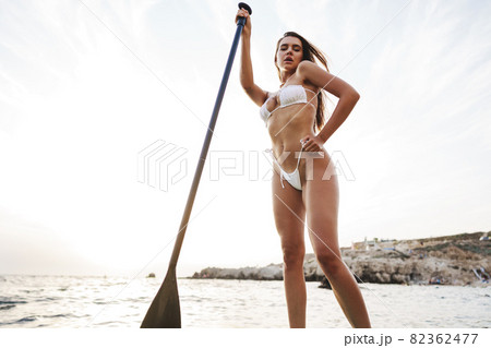 Beautiful model paddlbording relaxing in the sea with clean water 82362477