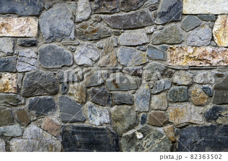texture, the background of the wall lined with natural stones  different shapes sizes and colors 82363502