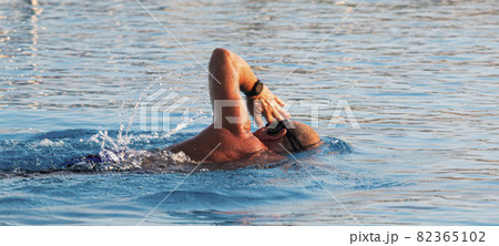 Man swimming laps in a pool Man swimming laps in a pool 82365102