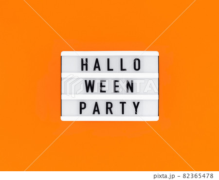 Light box with Halloween party text on orange background. 82365478