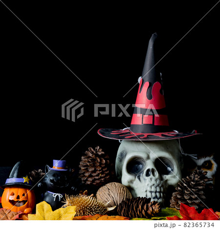 Halloween human skull, Halloween Pumpkins on an old wooden table in front of black background with free space for text. 82365734