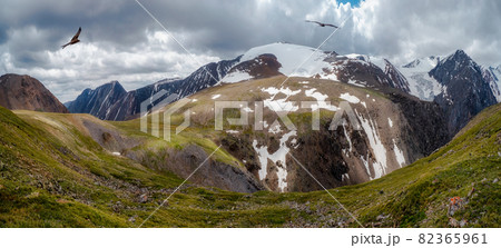 Scenic panoramic mountain landscape with great rocks in cloudy sky. Beautiful brown rock in sunlight and low clouds. 82365961
