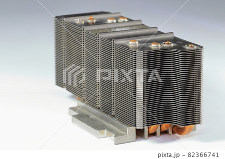 A close up view of passive CPU cooler with the aluminum fin and copper heat pipe structure isolate on white background. A close up view of passive CPU cooler with the aluminum fin and copper heat pipe structure isolate on white background. 82366741