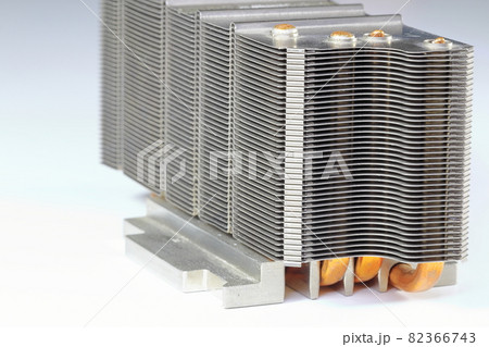 A close up view of passive CPU cooler with the aluminum fin and copper heat pipe structure isolate on white background. A close up view of passive CPU cooler with the aluminum fin and copper heat pipe structure isolate on white background. 82366743
