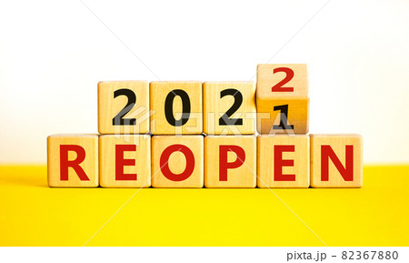 2022 reopen new year symbol. Turned a wooden cube and changed words 'Reopen 2021' to 'Reopen 2022'. Beautiful white background, copy space. Business, 2022 reopen new year concept. 2022 reopen new year symbol. Turned a wooden cube and changed words 'Reopen 2021' to 'Reopen 2022'. Beautiful white background, copy space. Business, 2022 reopen new year concept. 82367880