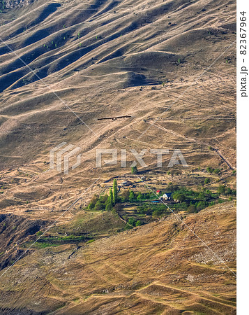 Mountain texture, mountain terrain. Small green oasis by the big red bare mountains. 82367964