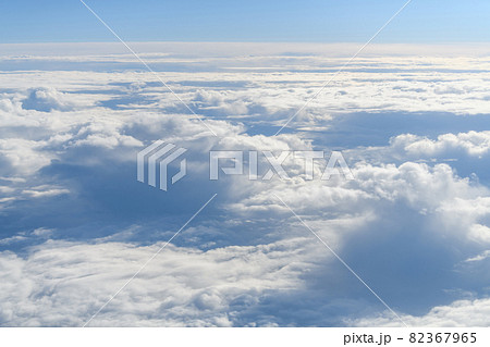 Clouds and sky as seen through window of an aircraft 82367965