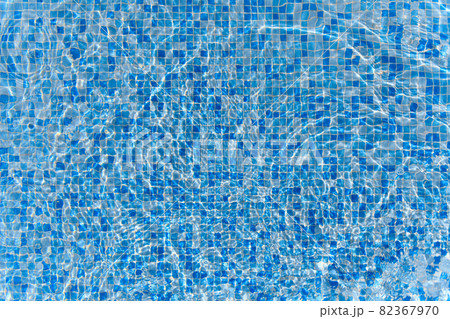 Swimming pool mosaic bottom caustics ripple like sea water and flow with waves background with sun light reflection 82367970