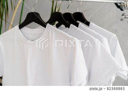 Row of white t-shirts on hangers on rack Row of white t-shirts on hangers on rack 82368863
