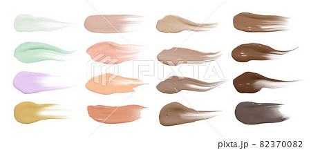 Foundation smears. Makeup concealer base. Isolated paint swatch. Liquid brown background. Foundation cream isolated on 82370082