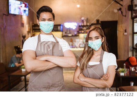 Waitress wearing a face mask at the coffee shop Waitress wearing a face mask at the coffee shop 82377122
