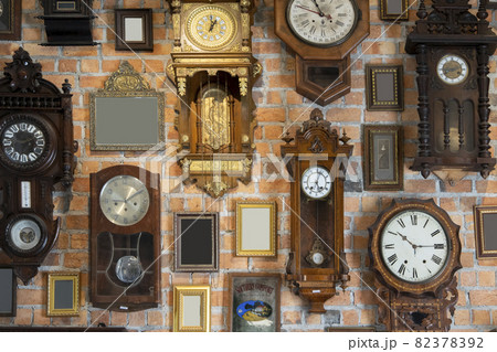 Collection of vintage clock and picture frame hanging on an brick wall Collection of vintage clock and picture frame hanging on an brick wall 82378392